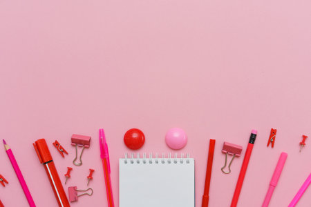 School supplies, stationery on pink background. Pens pencils notepad. Flat lay, top view. Back to school conceptの写真素材