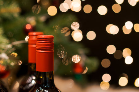 Christmas and New Year with champagne. New Years holiday two bottles wine on the background of the Christmas tree and bokeh. Concept of christmas and new year. Selective focusの写真素材