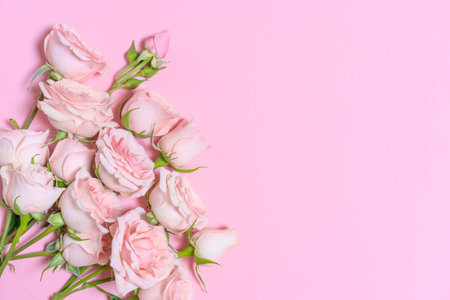 Delicate blooming pink flowers, blooming roses festive pink background, pastel bouquet with floral card, selective focusの写真素材