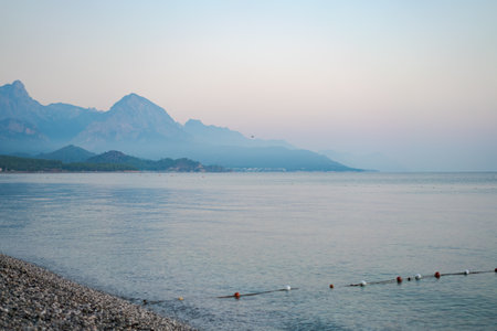 Calm sea against backdrop foggy mountains and blue sky, travel concept of beautiful places in turkeyの写真素材