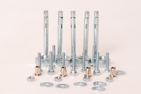 screws and nuts, bolts and self-tapping screws stand on a light background, construction conceptの写真素材