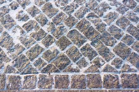 texture of natural stone paving stones in winter