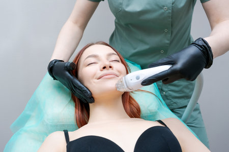 A woman is getting facial treatment with a woman assisting her