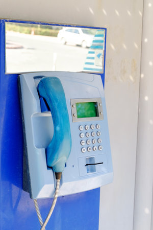 Blue phone booth with a green screen. The phone is blue.