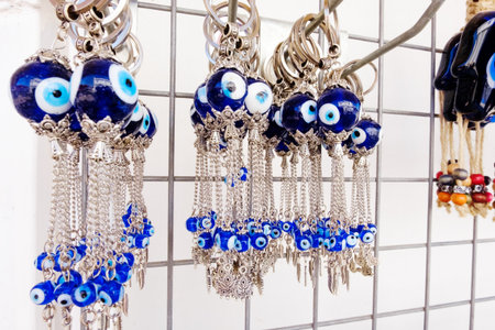 Rack of blue and white beads with a blue bead in the middle. The beads are hanging from a metal rack
