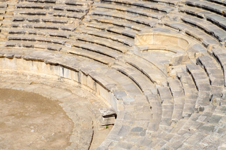 Stone wall with a stone bench in the middle. The bench is made of stone and is located in the center...