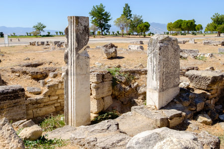 Stone pillar is in the middle of a field. There are other stone pillars in the backgroundの写真素材