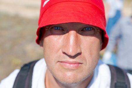 Man wearing a red hat and white shirt. He has a beard and a mustacheの写真素材