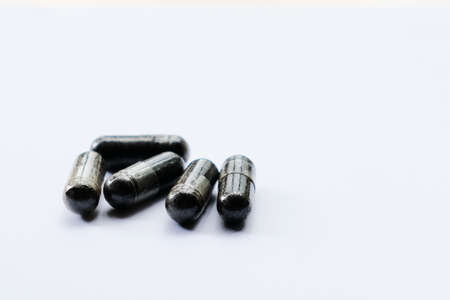 Black cumin capsules isolated on a black background. One of the plants that are often processed into herbal medicine is Black Seedの写真素材