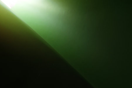 Coated green paper with the gradient in the corner, background textureの写真素材