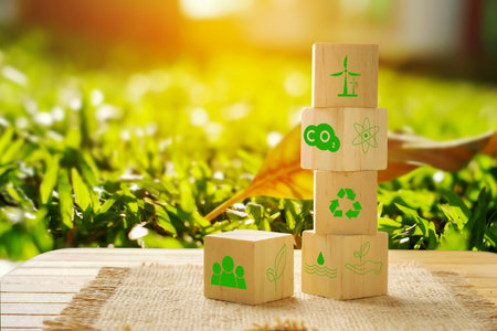 Wooden blocks with green recycling symbol on green grass background. Eco friendly conceptの写真素材
