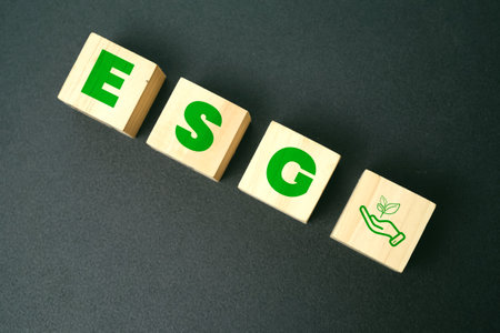 Wooden cubes with the word 'ESG' isolated on black backgroundの写真素材