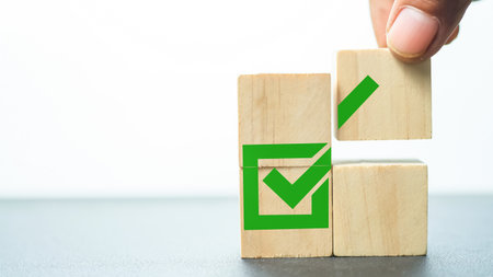 Wooden blocks with green tick mark. Business and success concept.の写真素材