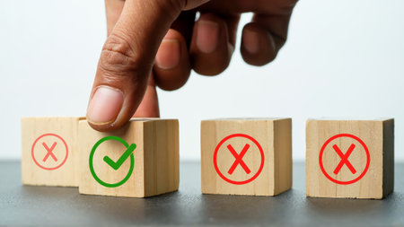 Close-up Of Person's Hand Choosing Yes Or No Wooden Cubesの写真素材