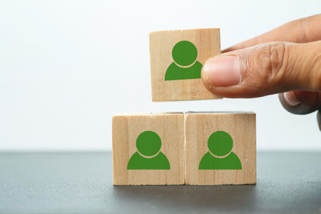 Wooden cube block with people icon on white background, business concept