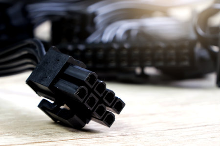 Closeup of black electric cable on wood background. Selective focus.の写真素材