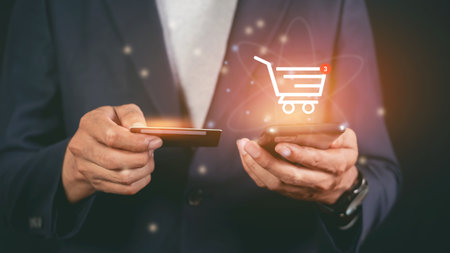 Male hand using smart phone making online payment by credit card. Shop online with a cartの写真素材