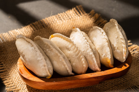 Frozen dumplings on a wooden plate, close-upの写真素材