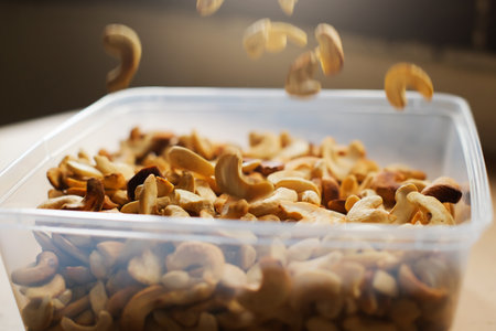 Raw cashew nuts in a plastic container. Shallow depth of field.の写真素材