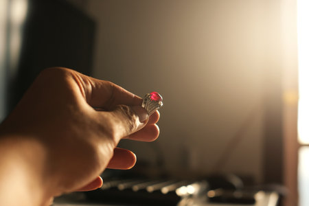 Man's hand holding a red screwdriver on a blurred background.の写真素材