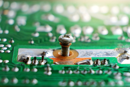 Macro photo of electronic circuit board with screws and pins. Technology backgroundの写真素材