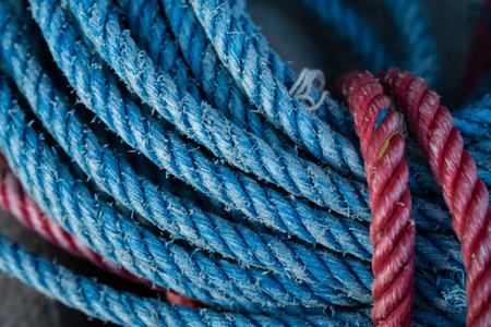 Close up of a bundle of blue and red ropes on a boatの写真素材