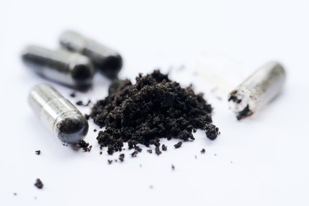 Pile of black powder and bullets isolated on white background. Selective focus.の写真素材