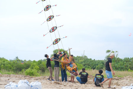 Lampung, Indonesia-10 September 2022: Traditional Kite Festival, Creative Kite Competition, Tourist Attraction, Young People Prepare and Fly Kites on the Beachのeditorial素材