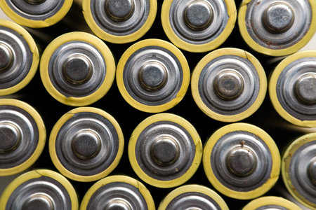 Batteries background. Close-up of yellow alkaline batteries.の写真素材
