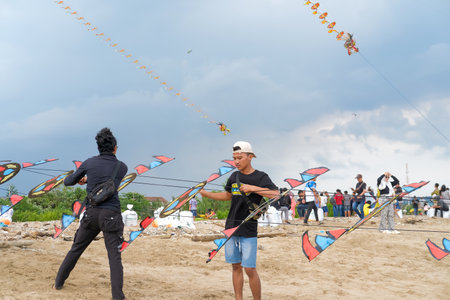 Lampung, Indonesia-10 September 2022: Traditional Kite Festival, Creative Kite Competition, Tourist Attraction, Young People Prepare and Fly Kites on the Beachのeditorial素材