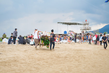 Lampung, Indonesia-10 September 2022: Traditional Kite Festival, Creative Kite Competition, Tourist Attraction, Young People Prepare and Fly Kites on the Beachのeditorial素材