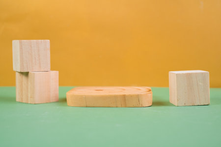 Wooden blocks on green and yellow background. Minimal concept.の写真素材