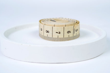 Measuring tape on a white background. Selective focus and shallow depth of field.の写真素材