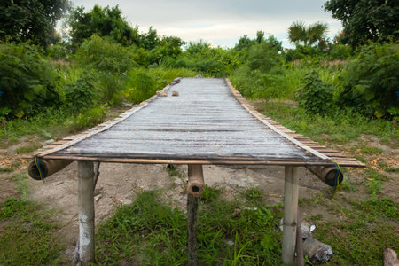 Wooden bridge over the river in the village, close-up