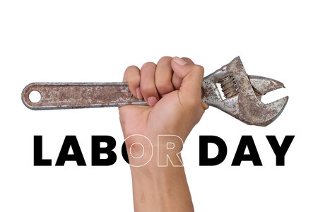 Labor day concept. Hand holding a wrench isolated on white background.の写真素材