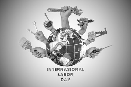 International Labor Day. Hands holding different tools around the globe on grey backgroundの写真素材