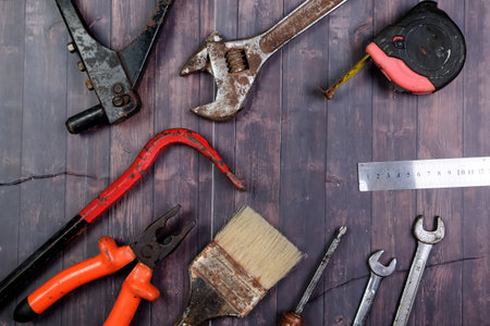 Set of tools on a wooden background. Top view with copy space.