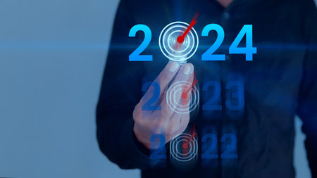 Businessman holding light bulb with target 2022 to 2024 for preparation for happy new year concept. new business in new year, start up, action plan and strategy in new business.の写真素材