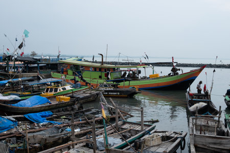 Rows of fishing net boats parked at a fish auction in Indonesiaの写真素材