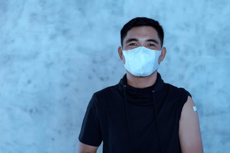 Protection against viruses. Confident Asian mature man with plastered arm after anti-virus injection. I've Got the Vaccineの写真素材
