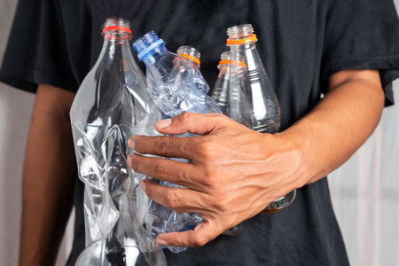 A man collects trash bottles. Recycling, Environment and ecology conceptの写真素材