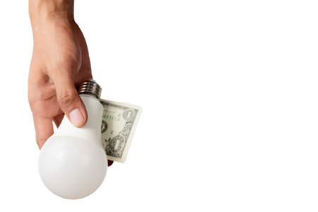 Hands holding light bulbs and banknotes, Electricity prices rise sharply. Electricity price increase conceptの写真素材