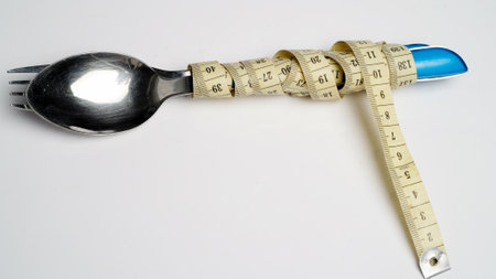 Fork and spoon tied with measuring tape, Weight control conceptの写真素材