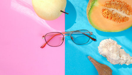 Summer blue and pink banner with fruits, glasses and sea shells. Summer vacation background compositionの写真素材