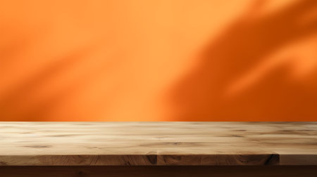 Empty wooden table on abstract orange background for product presentation, copy spaceの写真素材