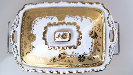 Ceramic plate with golden pattern on white background, closeupの写真素材