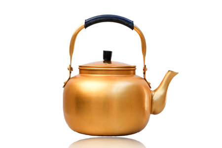 Gold metal kettle on white background. Tea pot.の写真素材