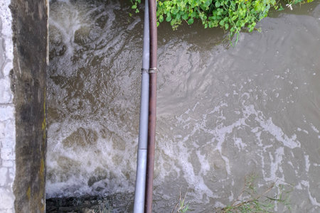 Water Flowing Through Irrigation Channel Pipesの写真素材