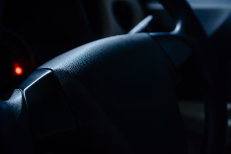 Close-up Of A Vehicle Steering Wheel With Soft Lighting And Moody Atmosphere