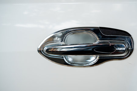 Close-Up Of A Polished Metal Door Handle On A White Vehicleの写真素材